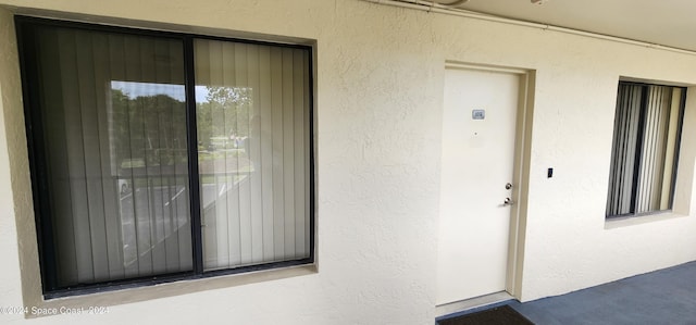 doorway to property with stucco siding