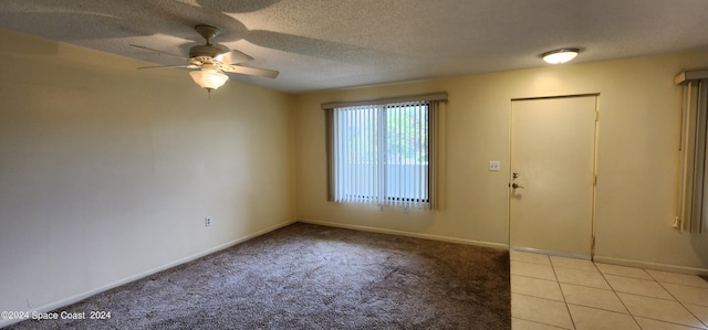 entryway with light tile patterned flooring, light carpet, a textured ceiling, baseboards, and ceiling fan