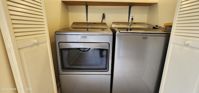 laundry room featuring washing machine and clothes dryer and laundry area