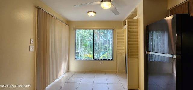 kitchen with baseboards, a ceiling fan, light tile patterned floors, and freestanding refrigerator