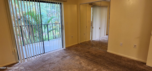 carpeted spare room featuring baseboards and a wealth of natural light
