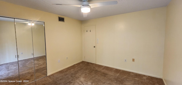 unfurnished bedroom featuring a textured ceiling, ceiling fan, and carpet floors