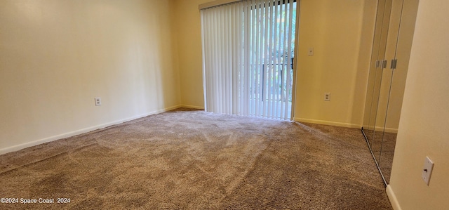 unfurnished room featuring baseboards and carpet flooring