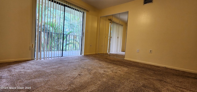 unfurnished room featuring carpet, baseboards, and visible vents