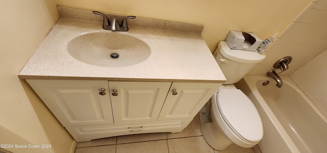 full bath with a bath, toilet, tile patterned flooring, and vanity