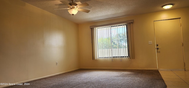 unfurnished room featuring ceiling fan, light carpet, and a textured ceiling