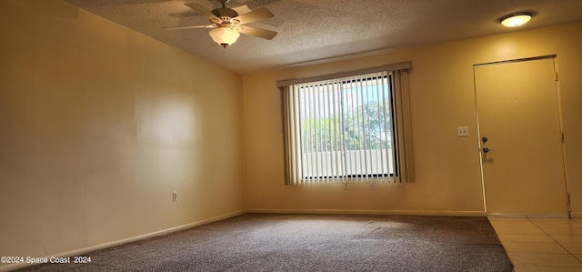 entryway featuring a textured ceiling, baseboards, carpet flooring, and a ceiling fan