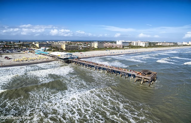 aerial view featuring a view of the beach, a water view, and a city view