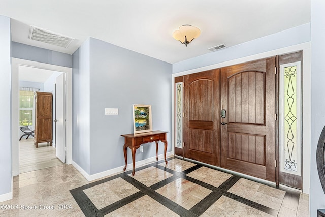 foyer entrance with light hardwood / wood-style floors