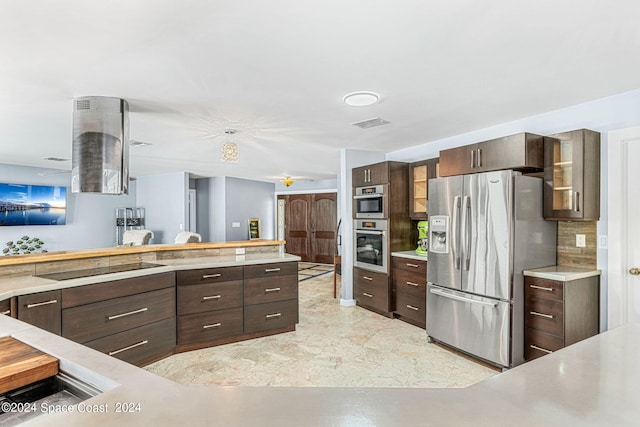 kitchen with stainless steel refrigerator with ice dispenser, dark brown cabinets, and backsplash