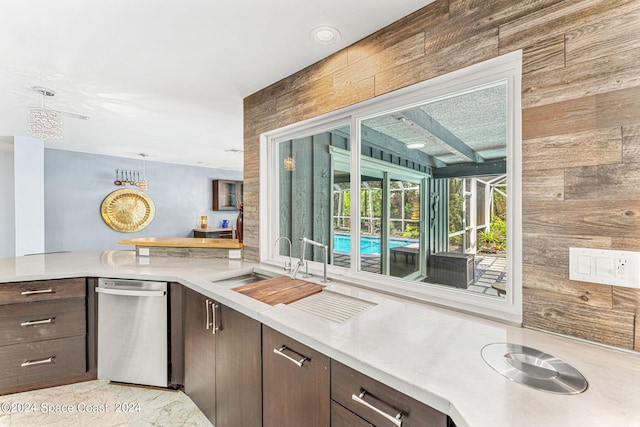 kitchen featuring wood walls and dark brown cabinets