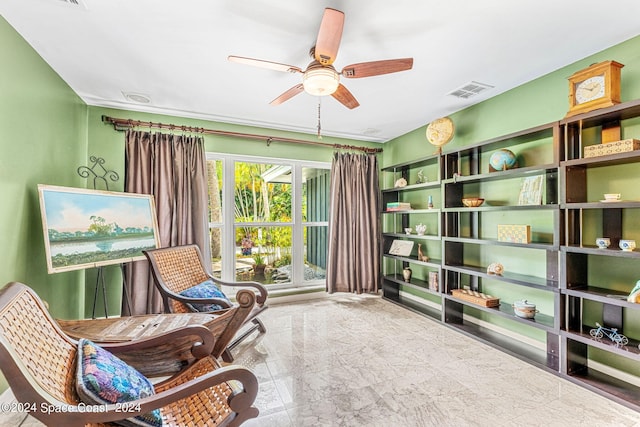 sitting room featuring ceiling fan