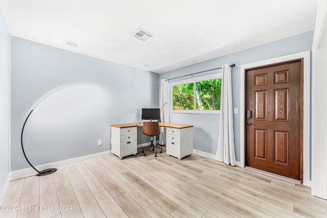 unfurnished office featuring light wood-type flooring