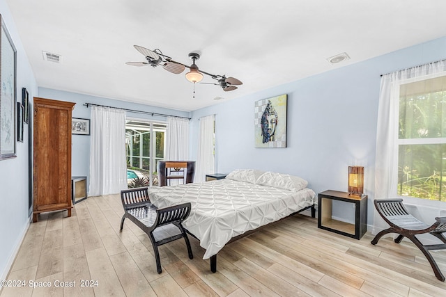 bedroom with light wood-type flooring and ceiling fan