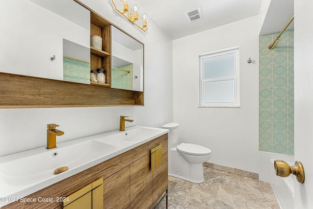 bathroom featuring vanity, toilet, and a shower