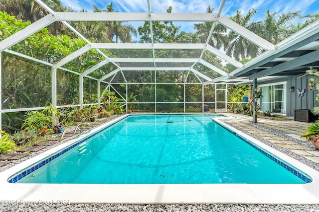 view of pool with glass enclosure