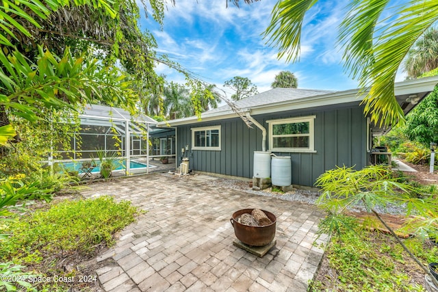 back of house with a patio area and a lanai