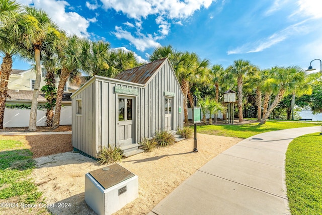 view of outbuilding with a yard