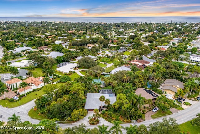 aerial view at dusk with a water view