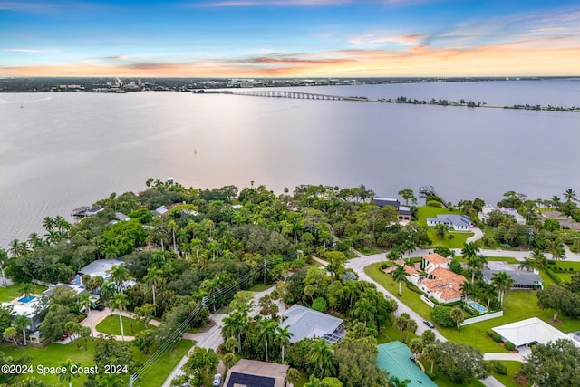 aerial view at dusk with a water view