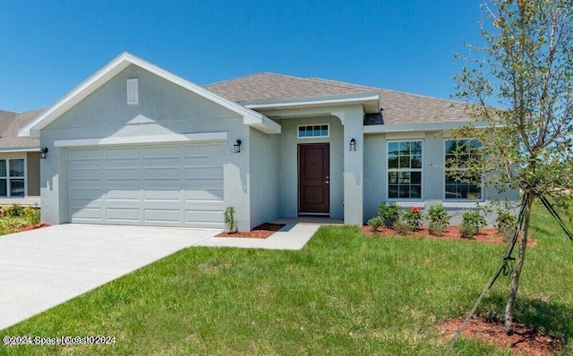 view of front facade with a front yard and a garage