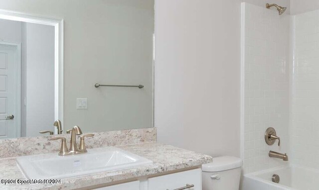 full bathroom featuring bathing tub / shower combination, toilet, and vanity