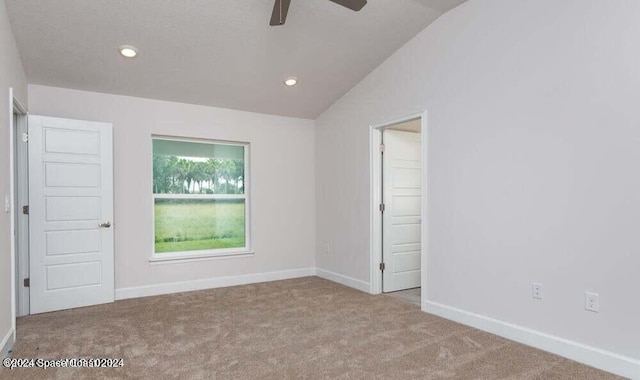 unfurnished bedroom with ceiling fan, carpet floors, and vaulted ceiling