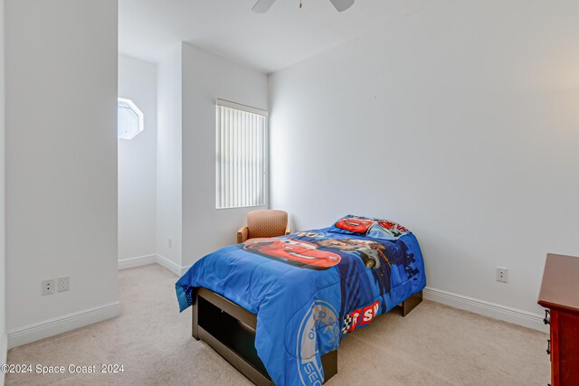 bedroom featuring ceiling fan and carpet