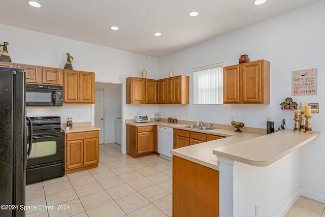 kitchen with light tile patterned floors, sink, kitchen peninsula, and black appliances