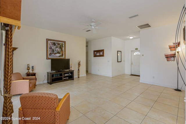 living room with ceiling fan and light tile patterned floors