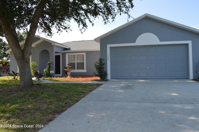 single story home featuring a garage