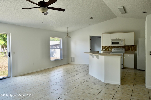 kitchen featuring decorative backsplash, pendant lighting, vaulted ceiling, light tile patterned floors, and white appliances