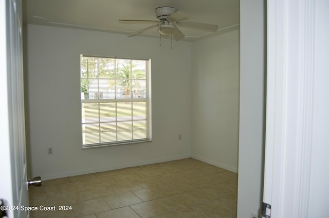 tiled empty room with ceiling fan