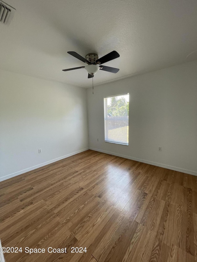 unfurnished room featuring ceiling fan and wood-type flooring