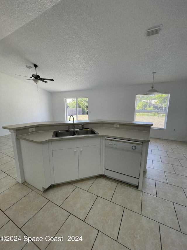 kitchen with dishwasher, sink, a textured ceiling, light tile patterned floors, and ceiling fan