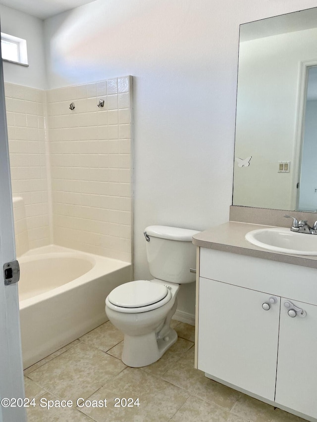 full bathroom featuring tile patterned flooring, tiled shower / bath, toilet, and vanity