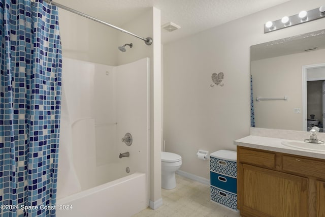 full bathroom with shower / bath combo, toilet, tile patterned floors, a textured ceiling, and vanity