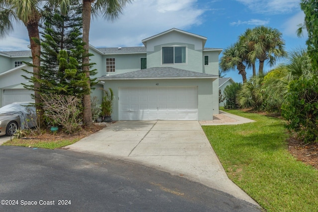 view of front of house with a front yard and a garage