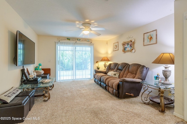 living area featuring carpet and a ceiling fan