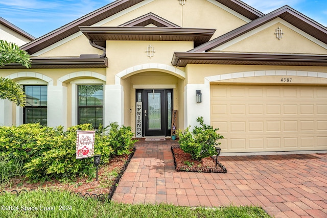 doorway to property with a garage