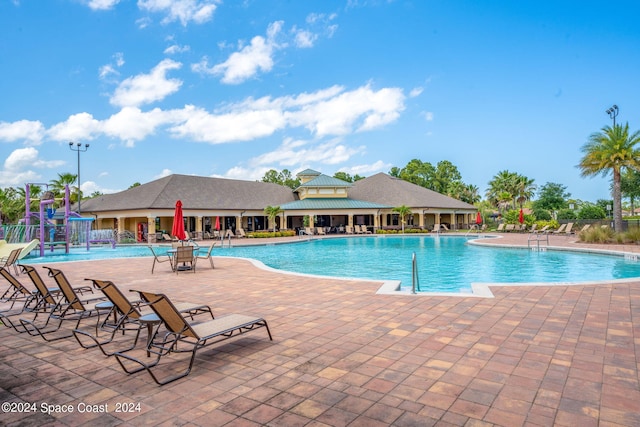 view of pool with pool water feature and a patio area