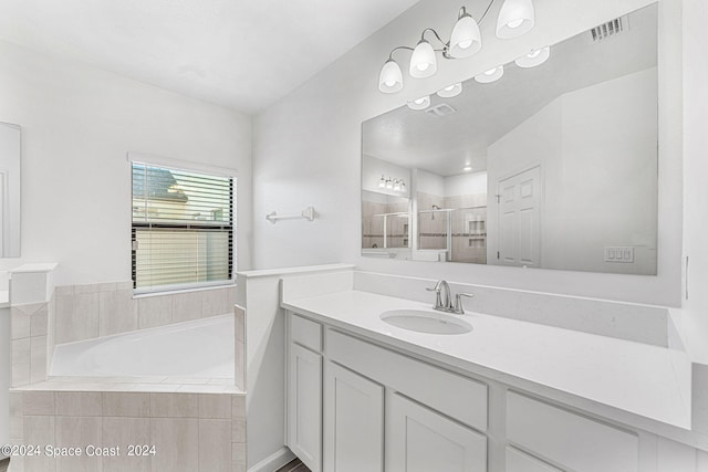 bathroom featuring shower with separate bathtub and vanity