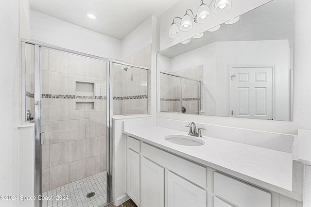 bathroom featuring vanity and an enclosed shower