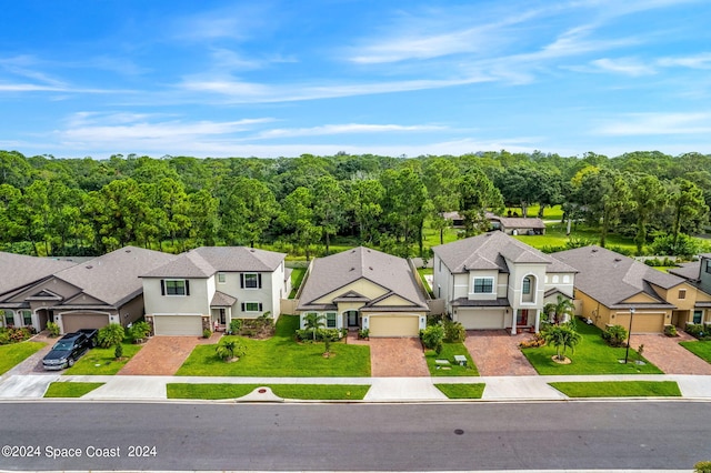 view of front of property with a front lawn and a garage