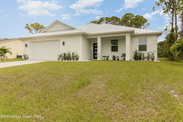 view of front of home with a front lawn and a garage