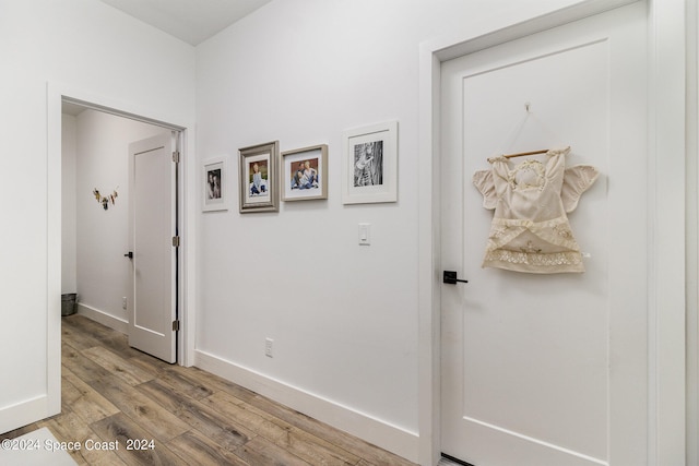 hallway with light hardwood / wood-style flooring