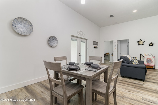 dining area featuring french doors and light hardwood / wood-style flooring