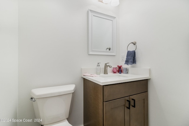 bathroom featuring toilet and vanity