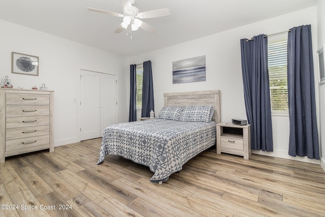 bedroom with a closet, ceiling fan, and hardwood / wood-style flooring