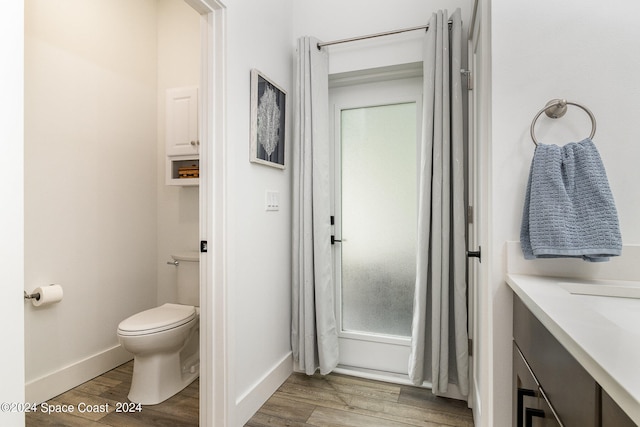 full bathroom featuring vanity, toilet, hardwood / wood-style floors, and shower / bathtub combination with curtain